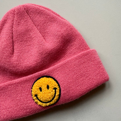 yellow embroidered smiley face detail on knit beanie