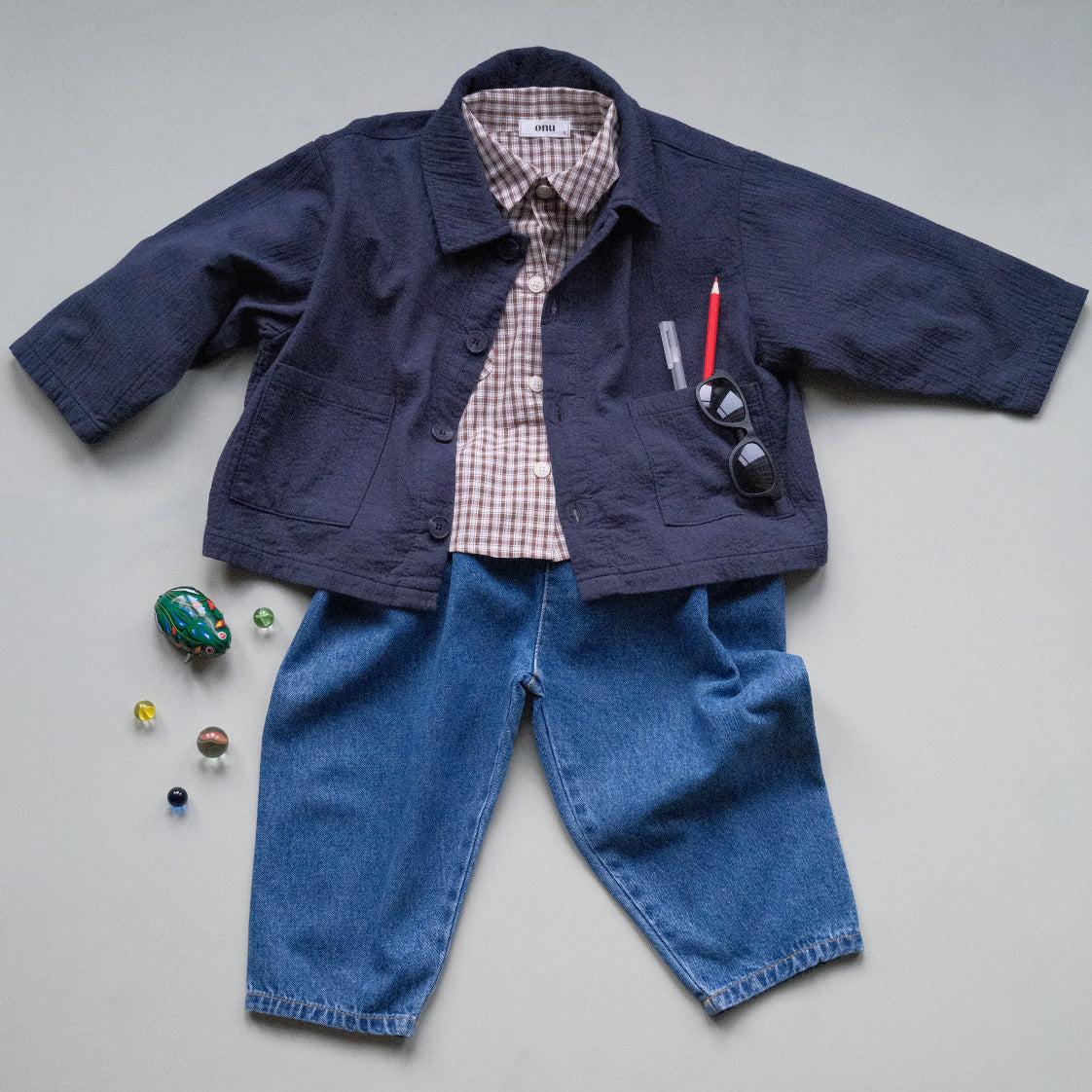 Children's navy blue chore jacket, brown check shirt and barrel leg jeans