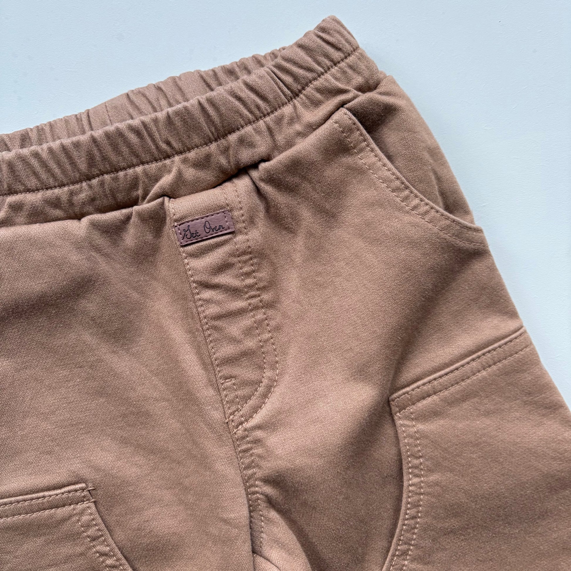 close up of children's chore pants with small faux leather label - Village Concept Store