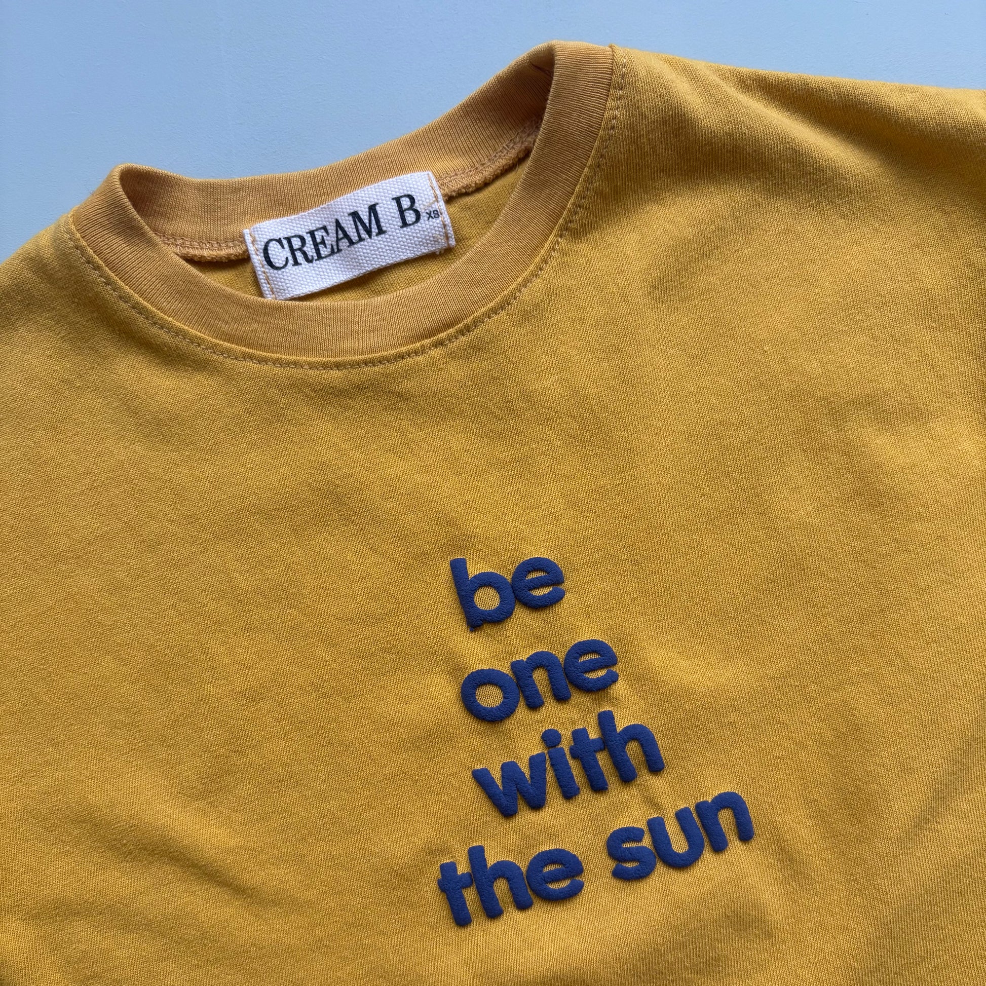 blue be one with the sun text print on yellow cotton t shirt